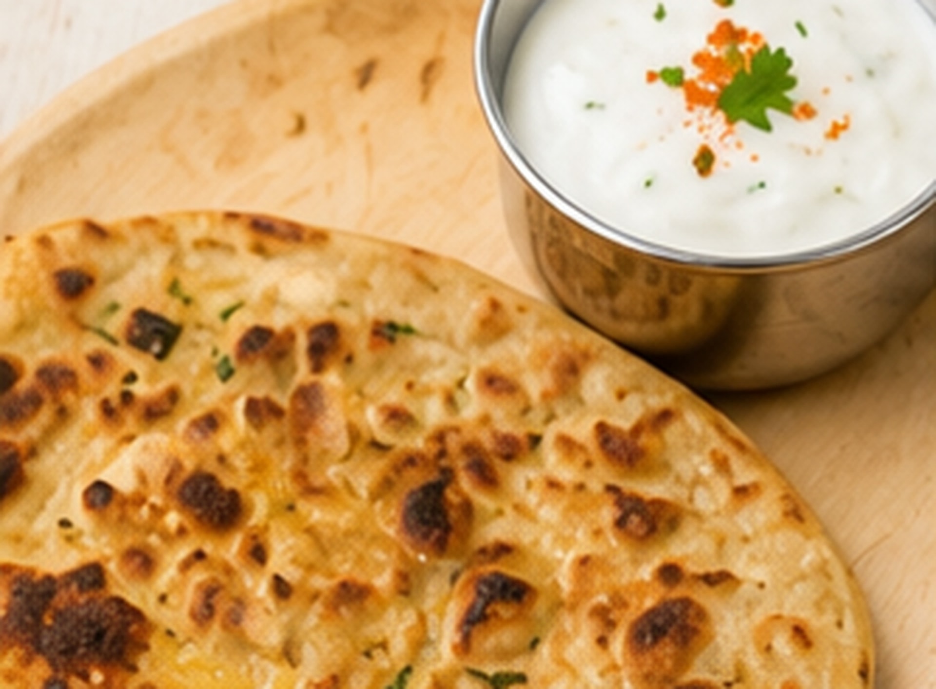 Paneer paratha with a bowl of curd